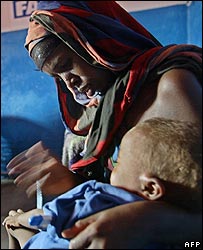 A displaced Somali woman comforts her child at an NGO clinic at Wajid, Somalia